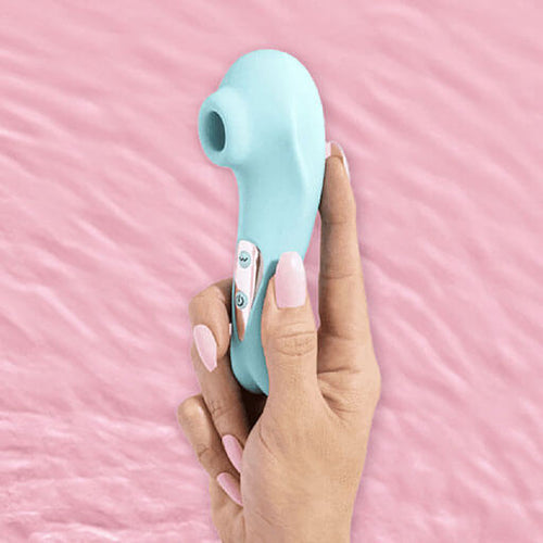 Hand with long luxurious pink nails holding the BlissVixen Honey Clitoral Suction Device, a sleek and elegant pleasure product designed for ultimate satisfaction