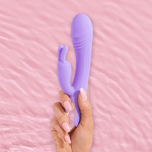 Hand with long luxurious pink nails holding the BlissVixen Arya Rabbit Vibrator, a sleek and elegant pleasure product designed for ultimate satisfaction