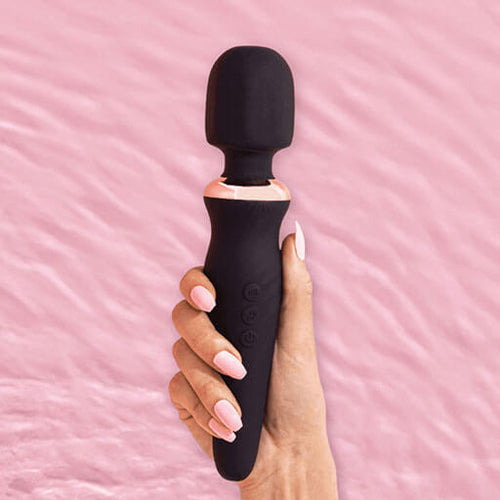 Hand with long luxurious pink nails holding the BlissVixen Cindy Massage Wand, a sleek and elegant pleasure product designed for ultimate satisfaction